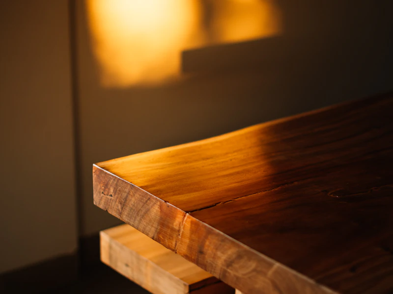 Live-edge walnut table edge in warm light