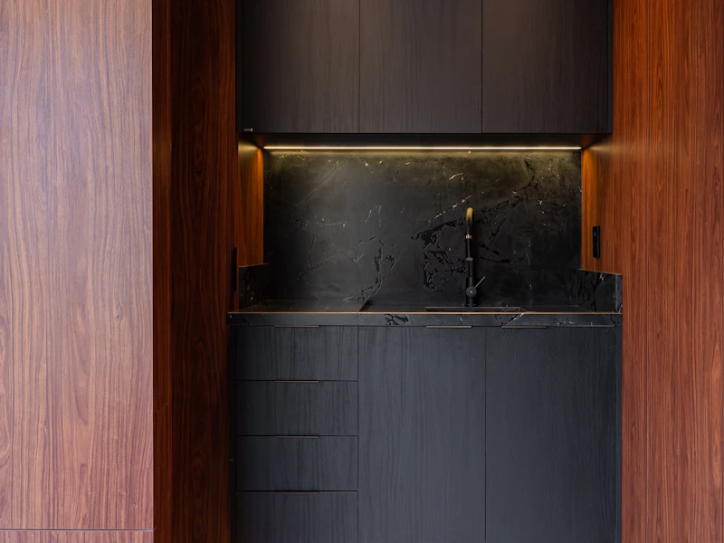 Dark oak kitchen with marble backsplash