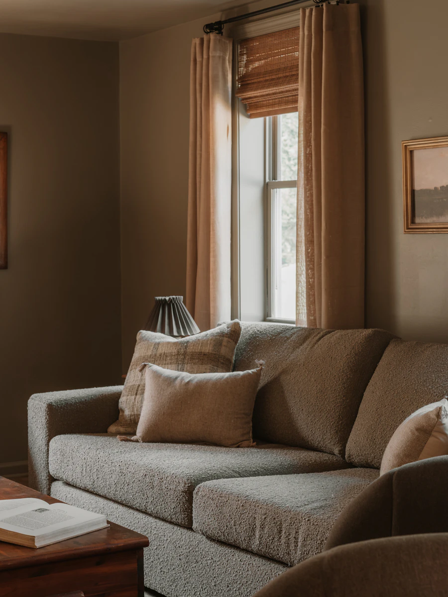 Taupe boucl&eacute; sofa in soft window light