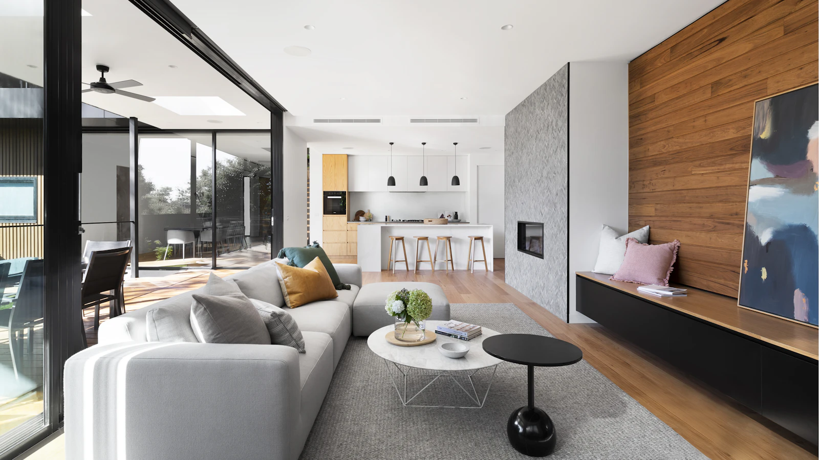 The Aster penthouse living space with timber feature wall